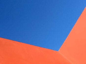 Low angle view of built structure against clear blue sky