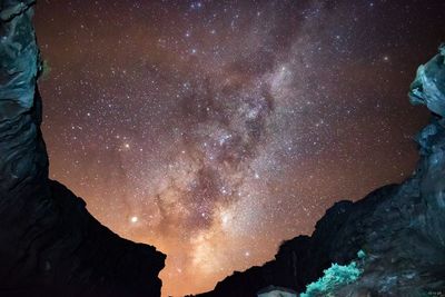 Low angle view of mountain against sky at night