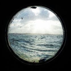 Scenic view of sea seen through glass window