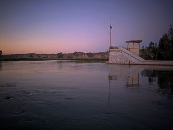 Reflection of building in lake at sunset