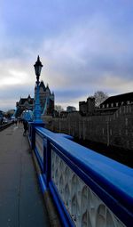 Statue in city against cloudy sky