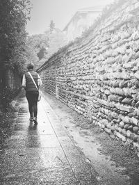 People on footpath against clear sky