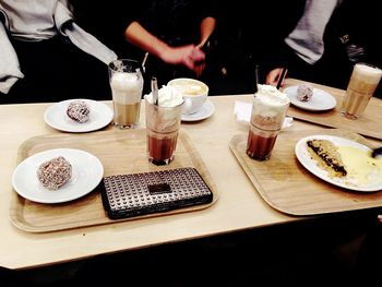 High angle view of coffee with whipped cream and cake on plate