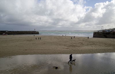 People on beach against sky