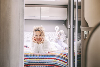 Portrait of young woman sitting in bathroom