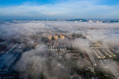 High angle view of a town covered by a sea of clouds