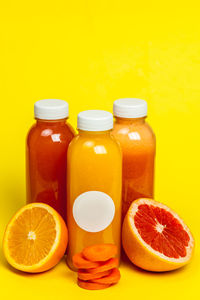 Various fruits on table against yellow background