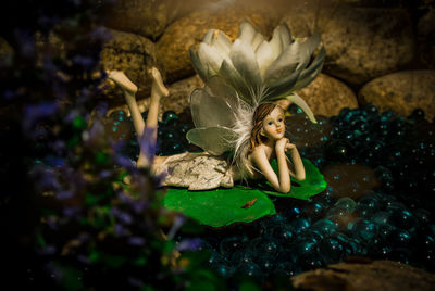 High angle view of woman sitting on rock