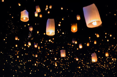 Low angle view of illuminated lanterns against sky