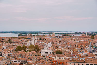 High angle view of townscape by sea against sky