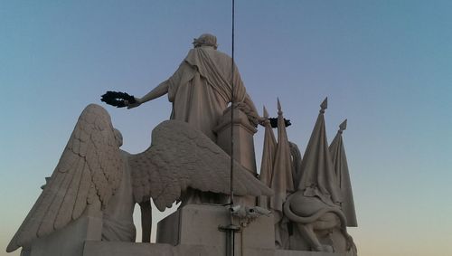 Low angle view of statue against blue sky