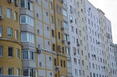 Low angle view of buildings in city against sky