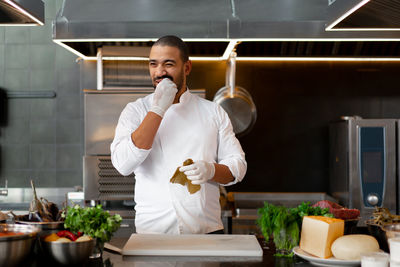 Young man preparing food in commercial kitchen