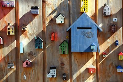 Mailbox and colorful houses on wooden wall