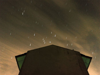 Low angle view of roof against sky at night