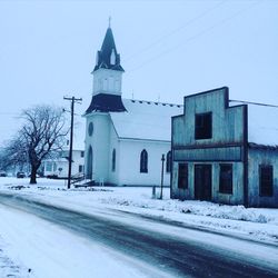 View of church in front of building against clear sky