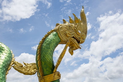 Low angle view of angel statue against sky