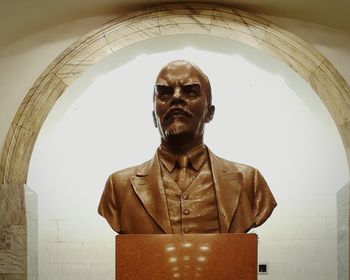 Low angle view of man standing against built structure