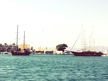 Ship sailing on sea against clear sky