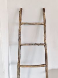 Close-up of ladder against wall at home