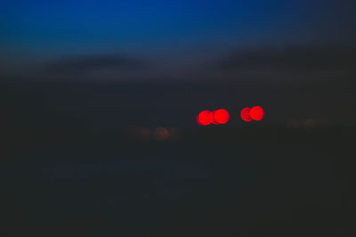 Close-up of illuminated car against sky at night