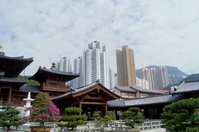 Panoramic view of buildings in city against sky