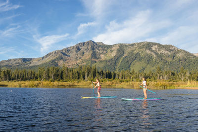 Stand up paddle boarding on lake tahoe next to mount tallac, ca