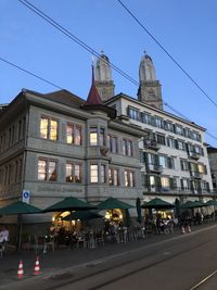 Buildings against clear blue sky in city