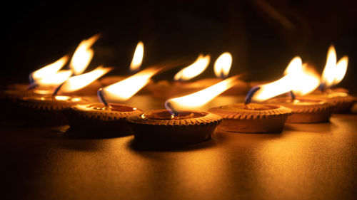 Close-up of illuminated candles on table