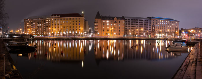 Beautiful city skyline with illuminated buildings on the shore promenade.