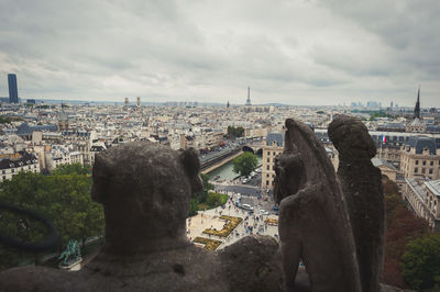 View of cityscape against cloudy sky