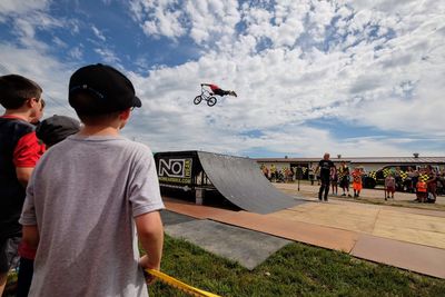 Group of people skateboarding against sky