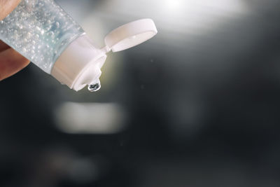 Close-up of hand holding glass bottle