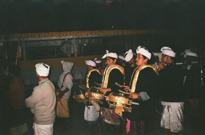 People at market stall at night