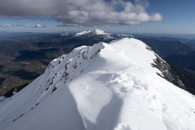 Scenic view of snowcapped mountains against sky