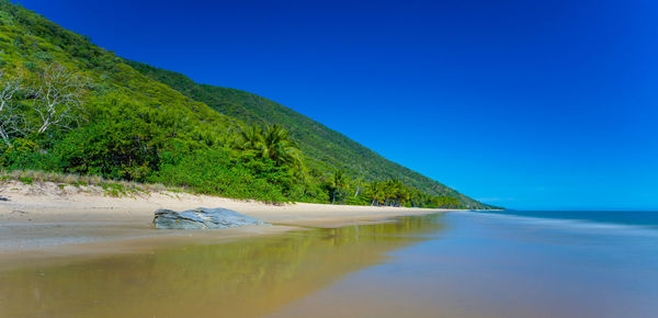 Scenic view of sea against clear blue sky