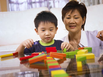 Grandmother playing with grandson at home