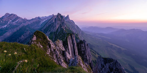 Scenic view of snowcapped mountains against sky during sunset