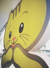 Low angle view of yellow text on wall