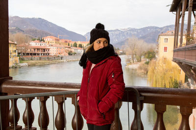 Woman standing on railing