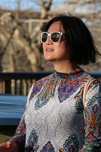 Woman wearing sunglasses standing outdoors