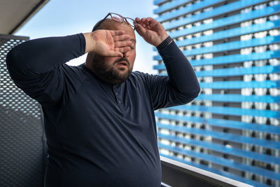 Side view of man standing in city