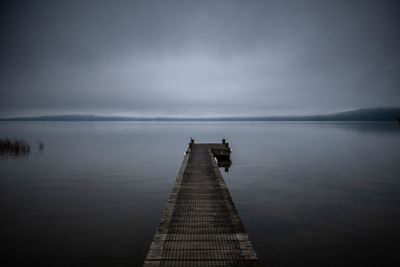 Pier over sea against sky