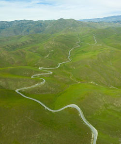 Green rolling hills idyllic scene in california after heavy spri