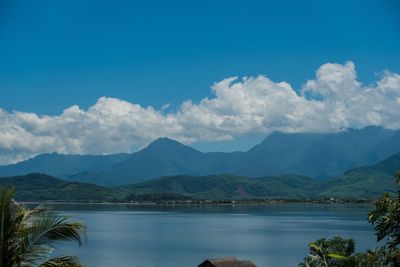 Scenic view of lake and mountains against sky