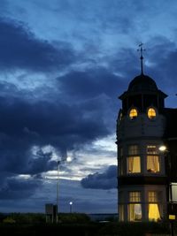 Low angle view of building against cloudy sky