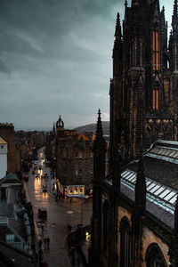 Buildings in city against cloudy sky