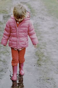 Rear view of woman standing on street