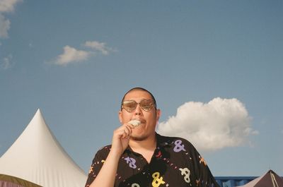 Portrait of young man against sky