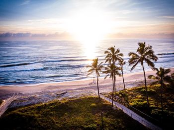 Scenic view of beach against sky during sunset